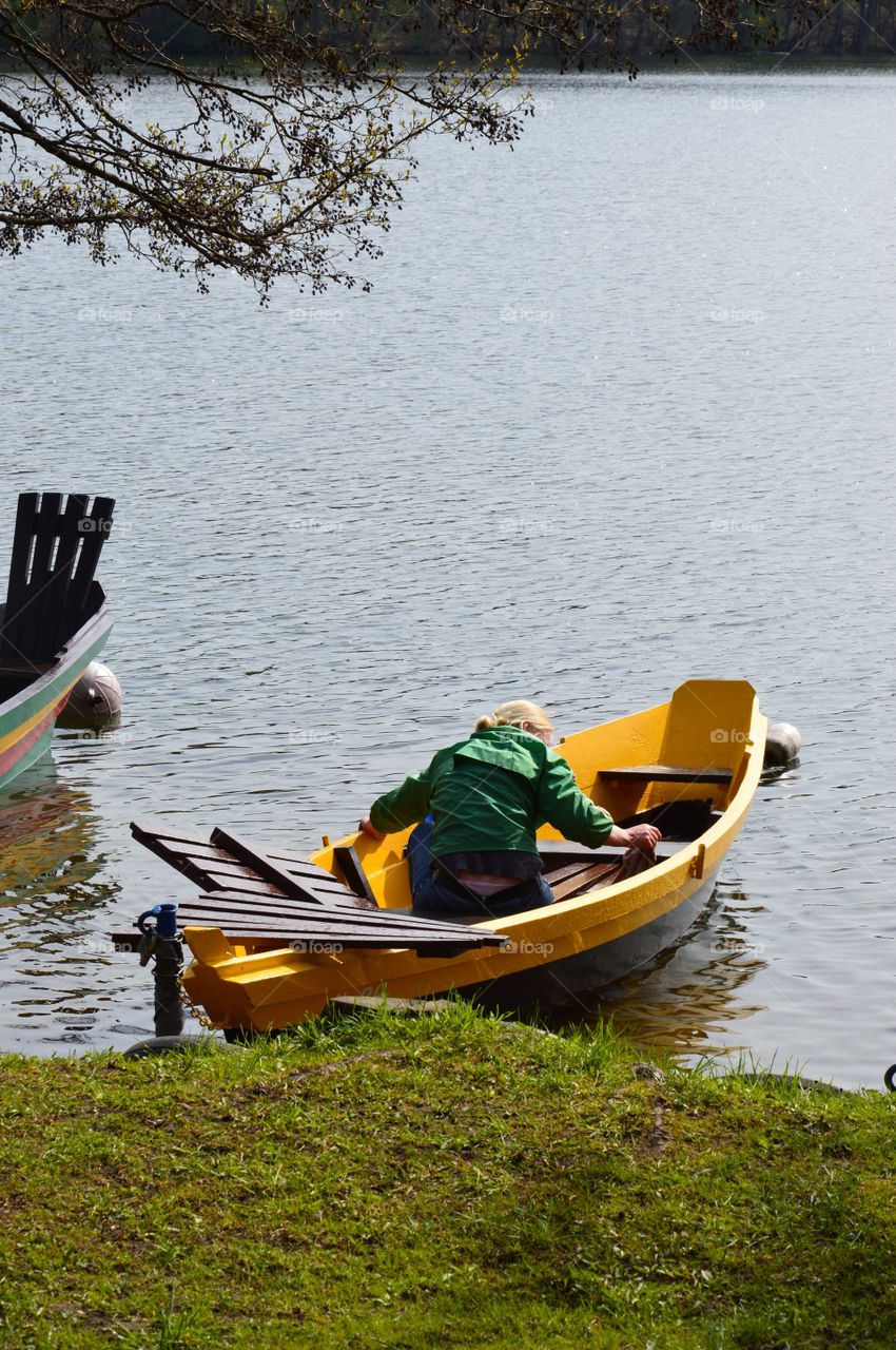 woman in yellow boat