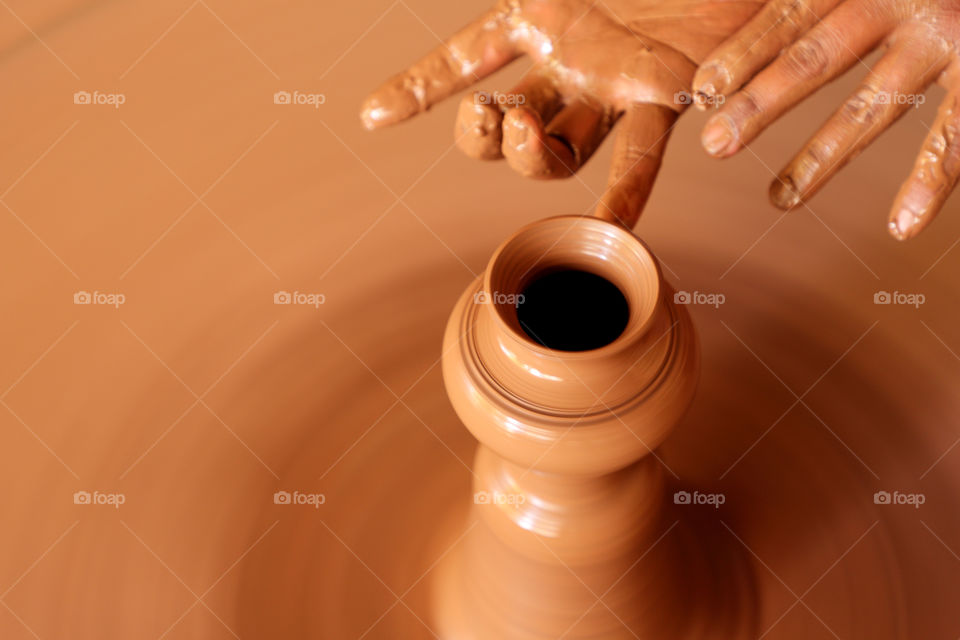 Potter making a pot with clay