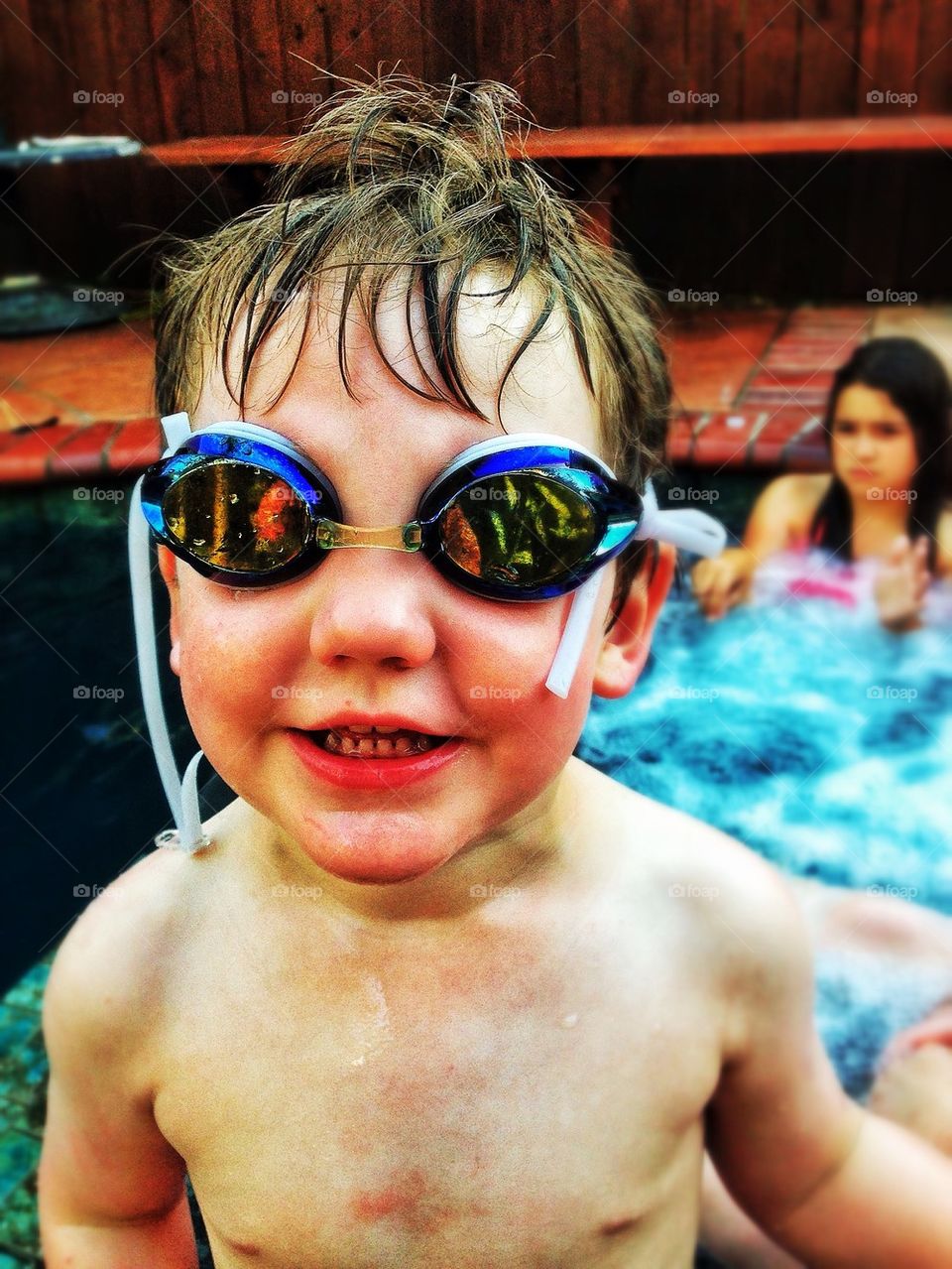 Smiling face of young boy in a pool