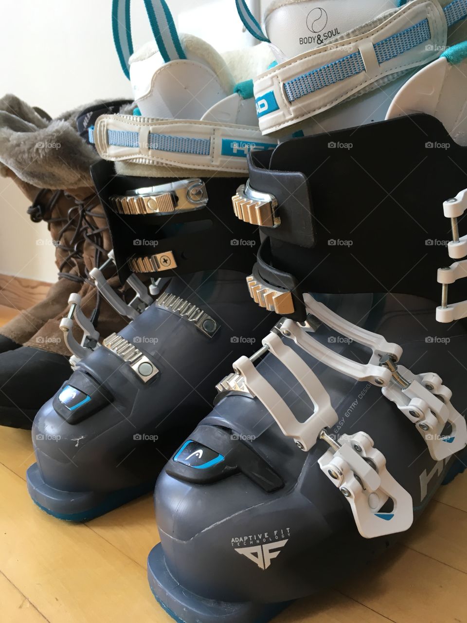 Ski boots and snow boots lined up by the door, ready for snow sport season