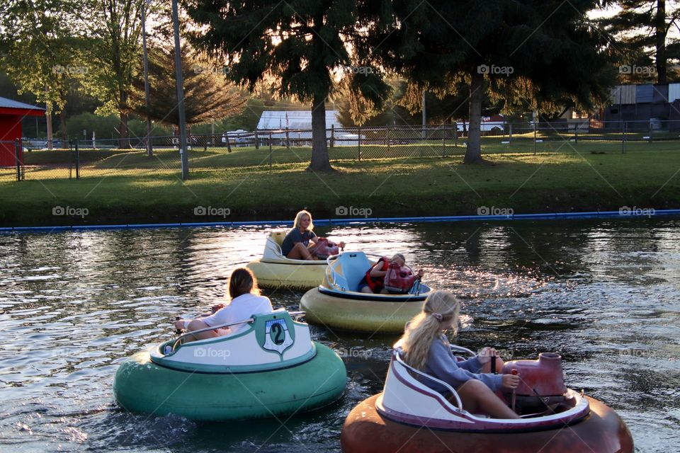 Kids having summertime fun riding in bumper boats 