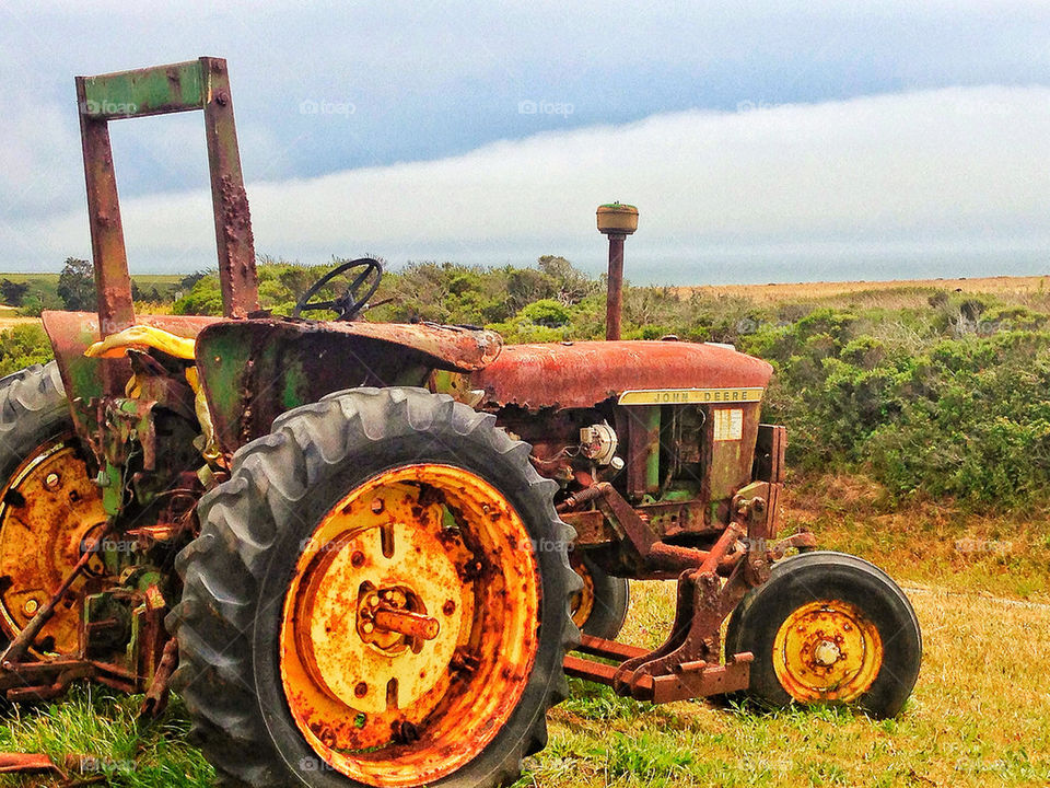 Rusting old tractor in a field