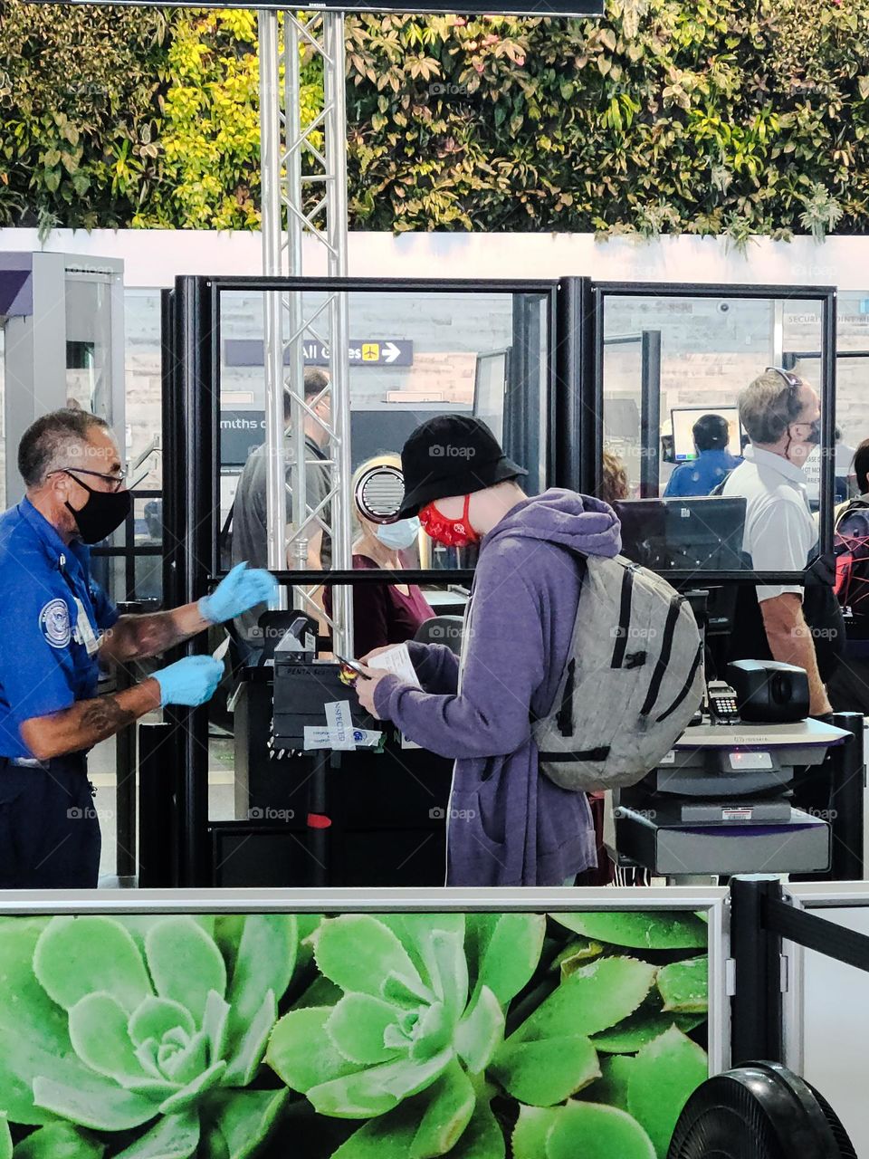 Checking in at the TSA line in the Oakland airport before going through security to board a flight 