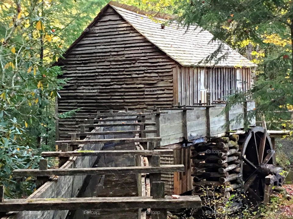 Old Grist Mill - A long wooden flume feeds from a long mill race that connects to the stream 100 yards or more upstream to the millpond and dam. A scenic valley filled with remnants of the old American Pioneers. A working mill produces cornmeal