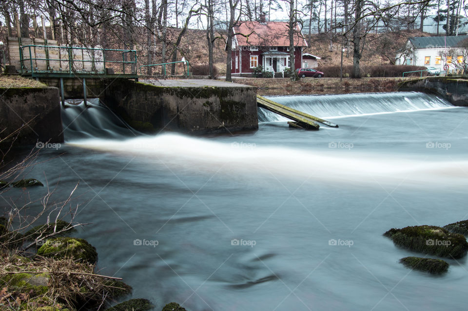 long exposure photo of the water flowing over a small dam in Borås Sweden