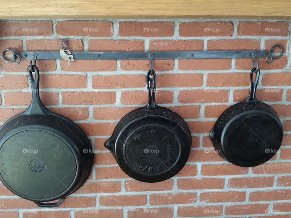 frying pans on hearth