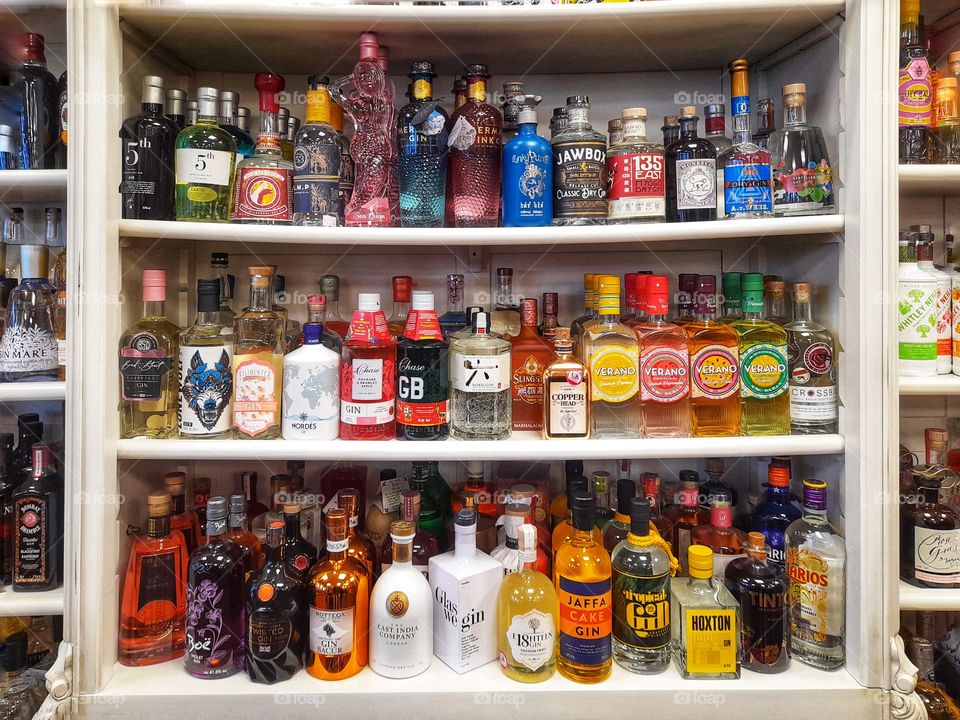 Selection of Gin bottles on shelf.
