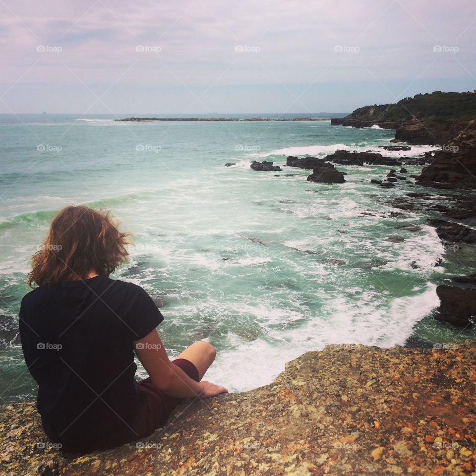 Boy overlooking ocean