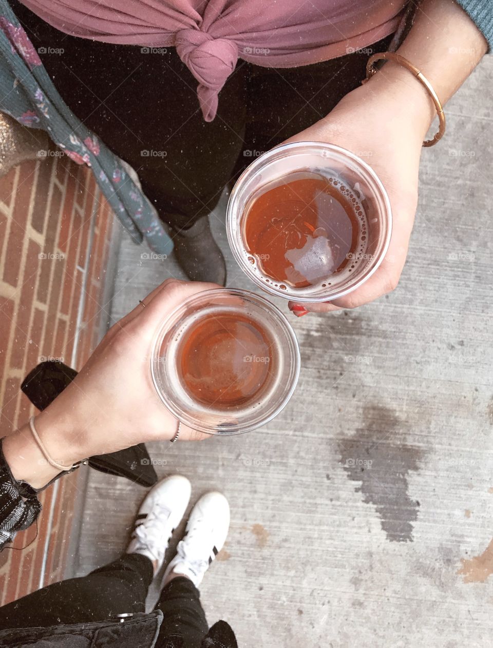 Friends cheers with cups of beer 