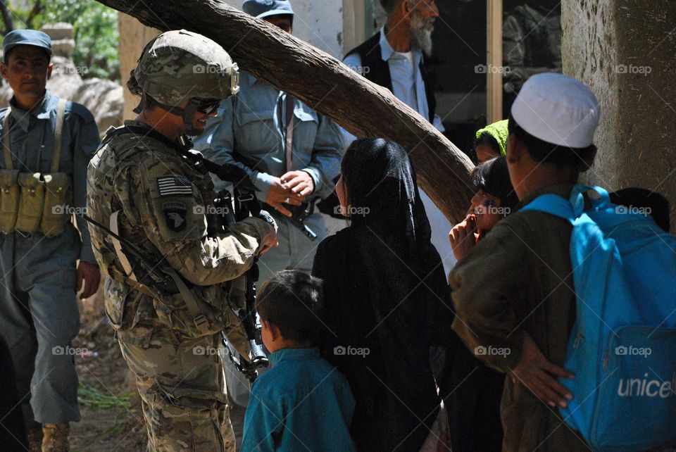 Show and Tell. U.S. Soldier sharing with Afghan children in Kabul Afghanistan 