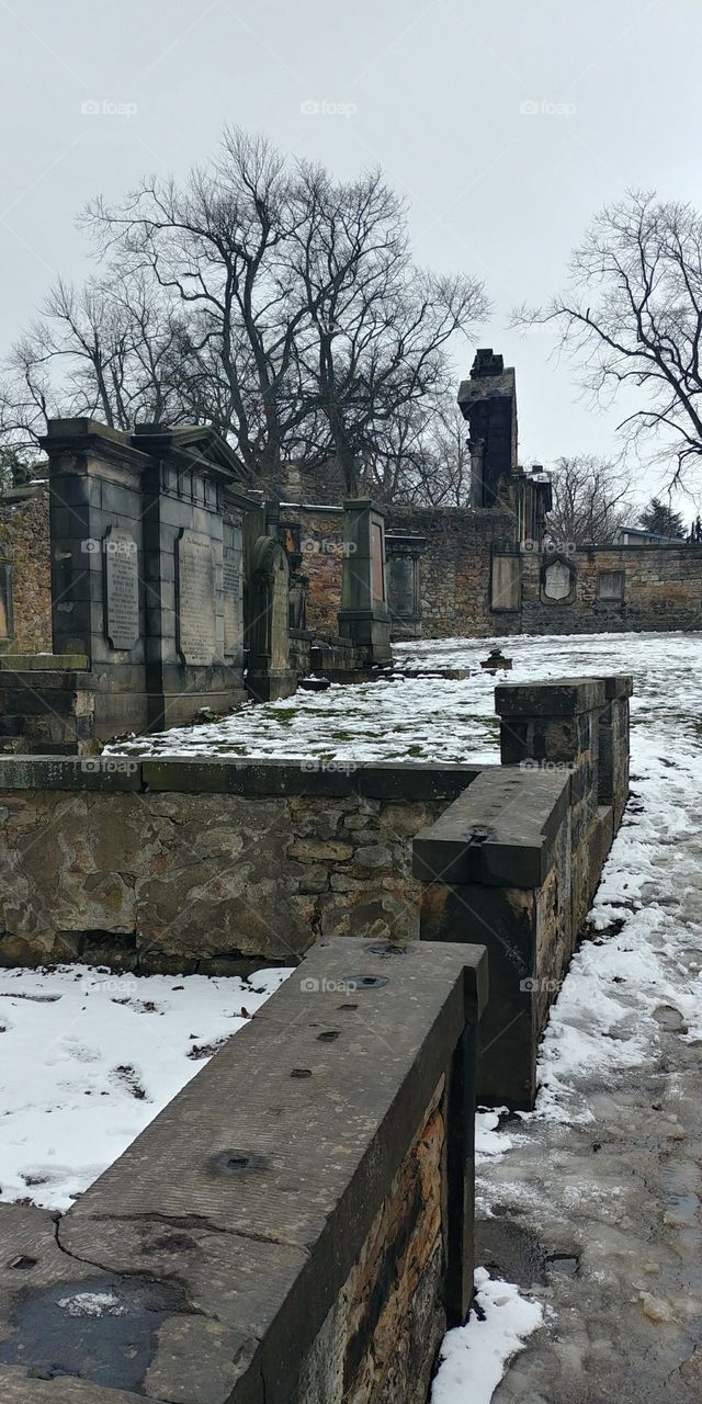 graves in a cemetery in the snow