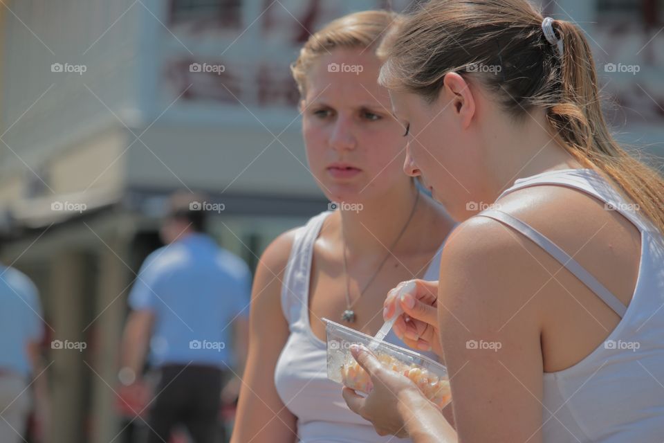 Eating In Public. Girl eating a snack in public.