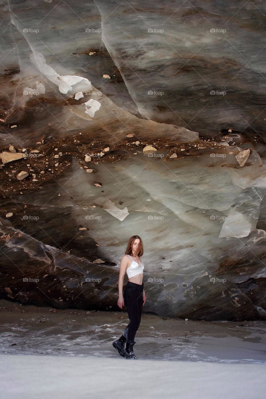 Girl in a top posing against an ice wall