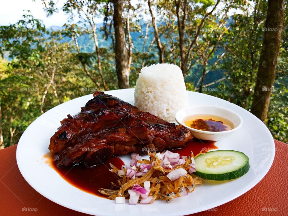 Grilled barbecue pork ribs with rice and fried anchovies