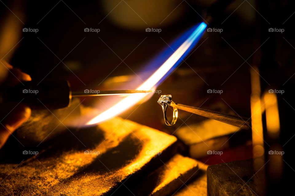 Orange and blue - image of ring bring made with blue flame torch and orange lighting