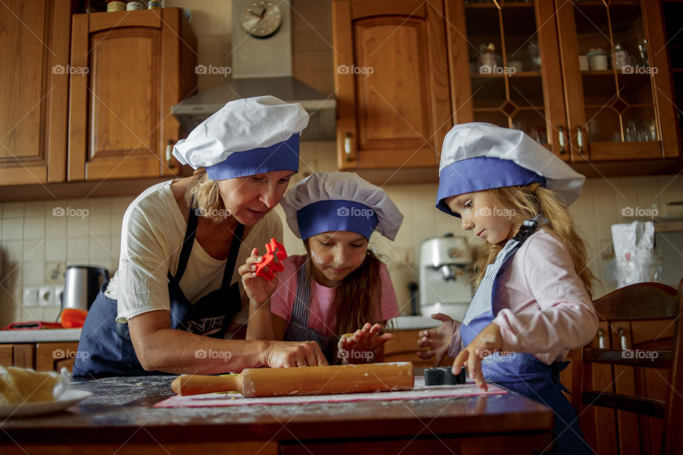 Little sisters cooking the biscuits 