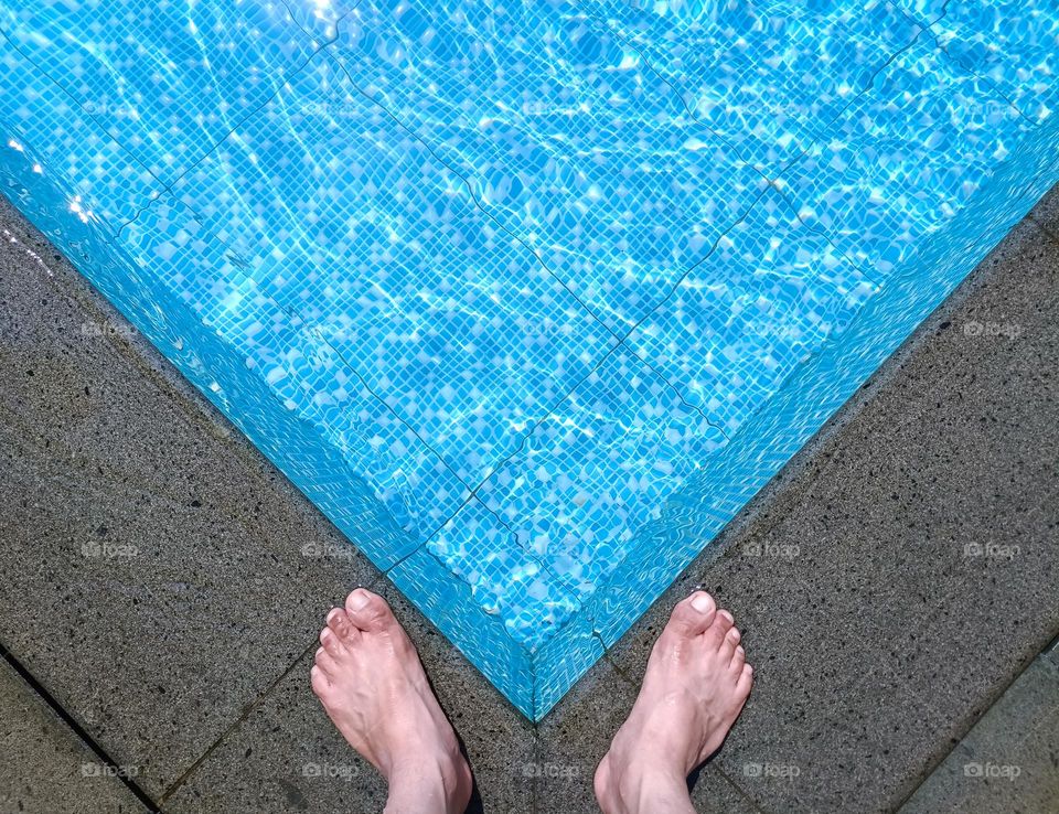 At the edge of the swimming pool