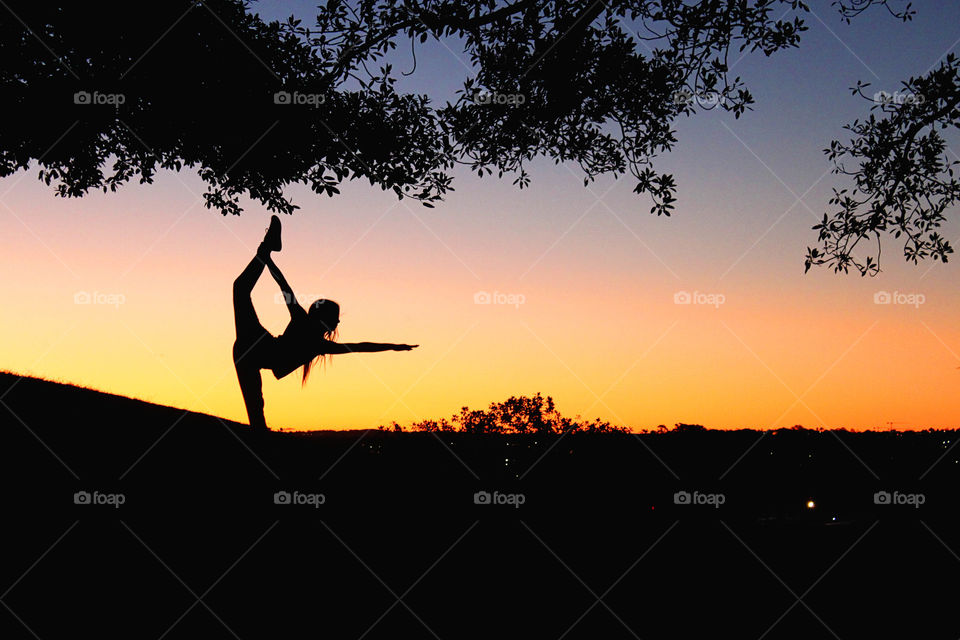 Silhouette of a women doing yoga