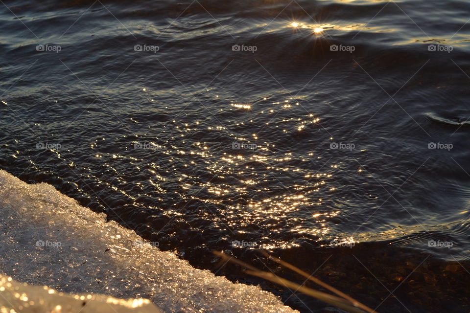 Golden water reflections at sunset