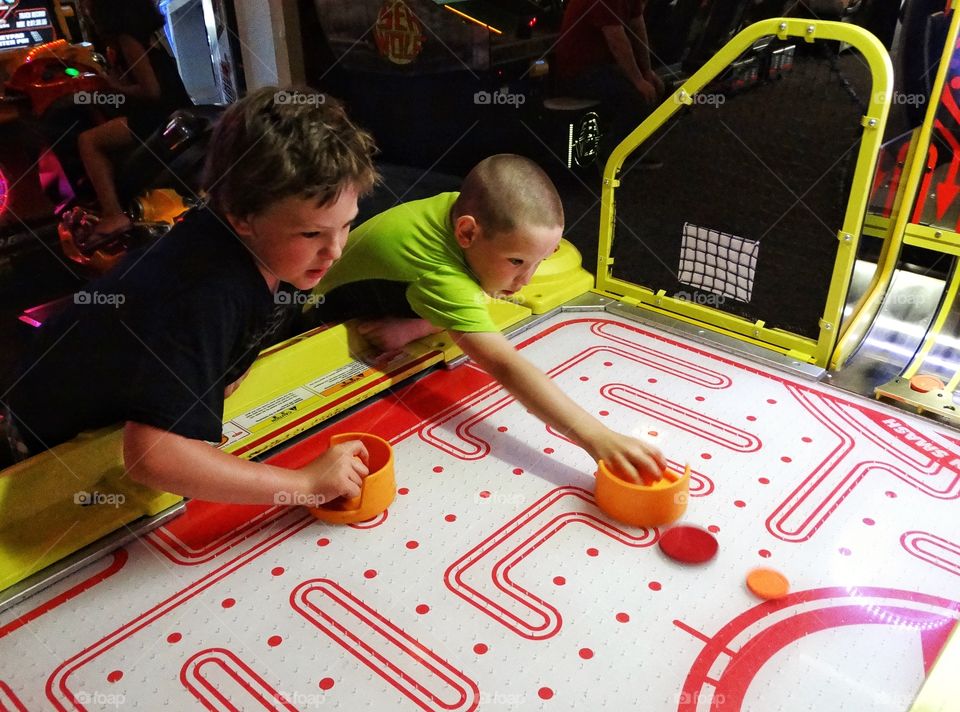 Children Playing Air Hockey
