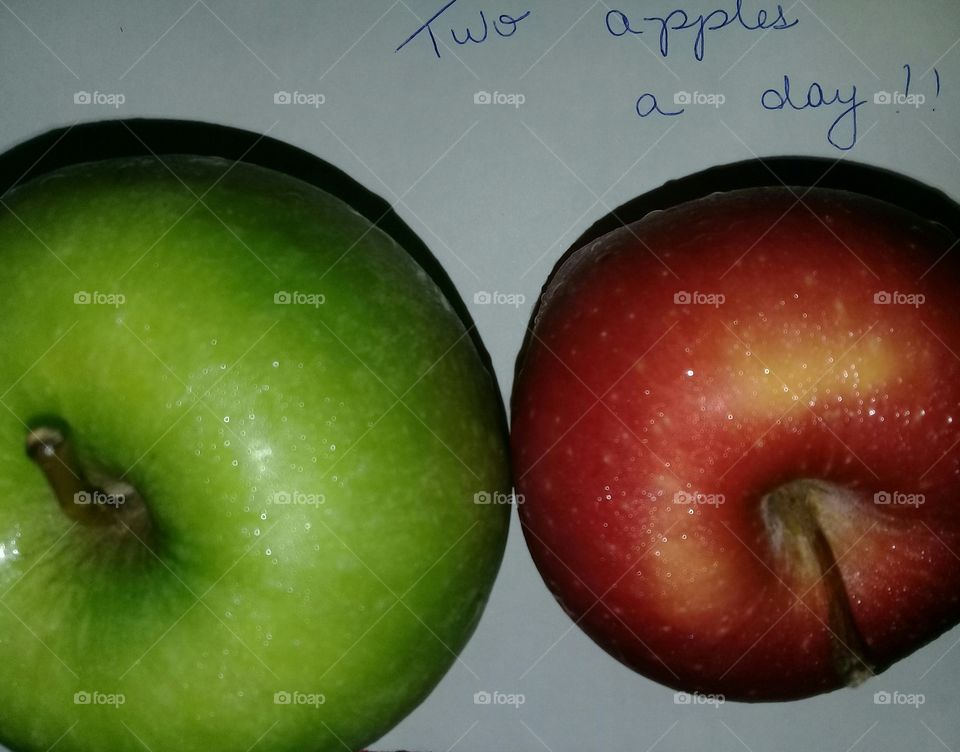 Two delicious apples. two apples a day. Green and red