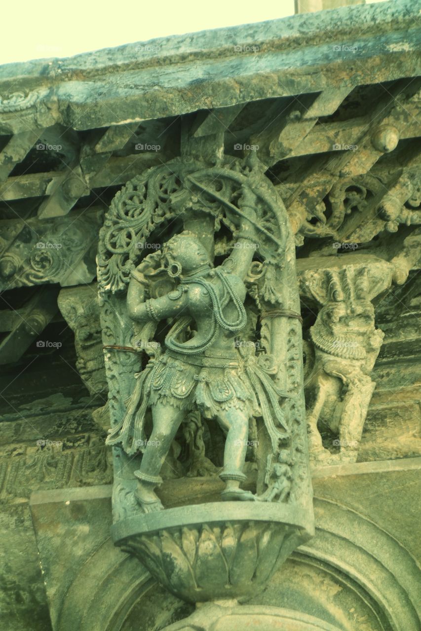 Belur Chennakeshava temple Apsara - aiming a dove