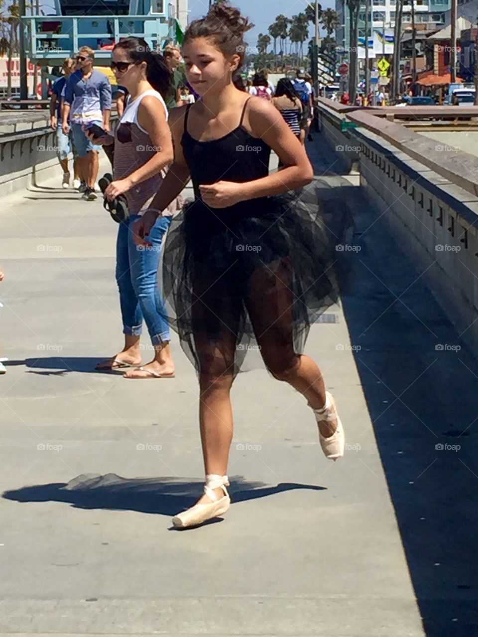 Beautiful ballerina running on the Venice Pier