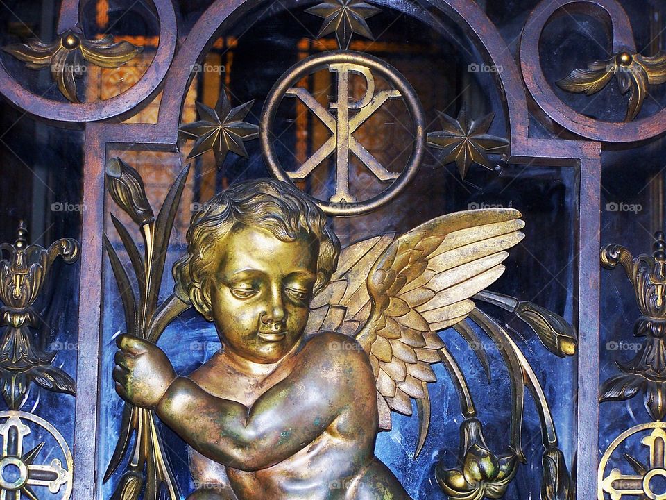 Cherub in bronze with Chi-Ro in Rome, Italy