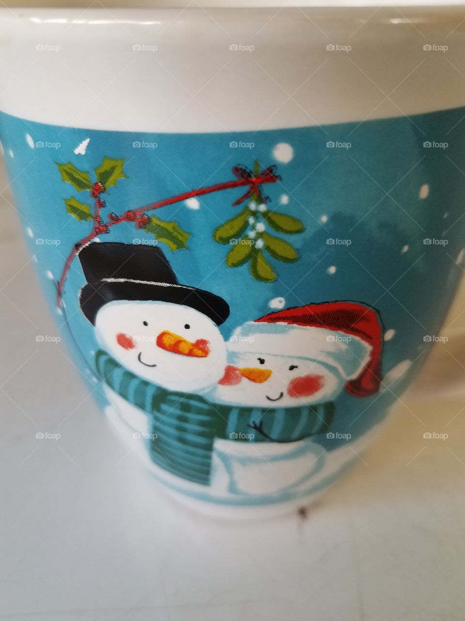 holiday season snowman and snow woman on a mug