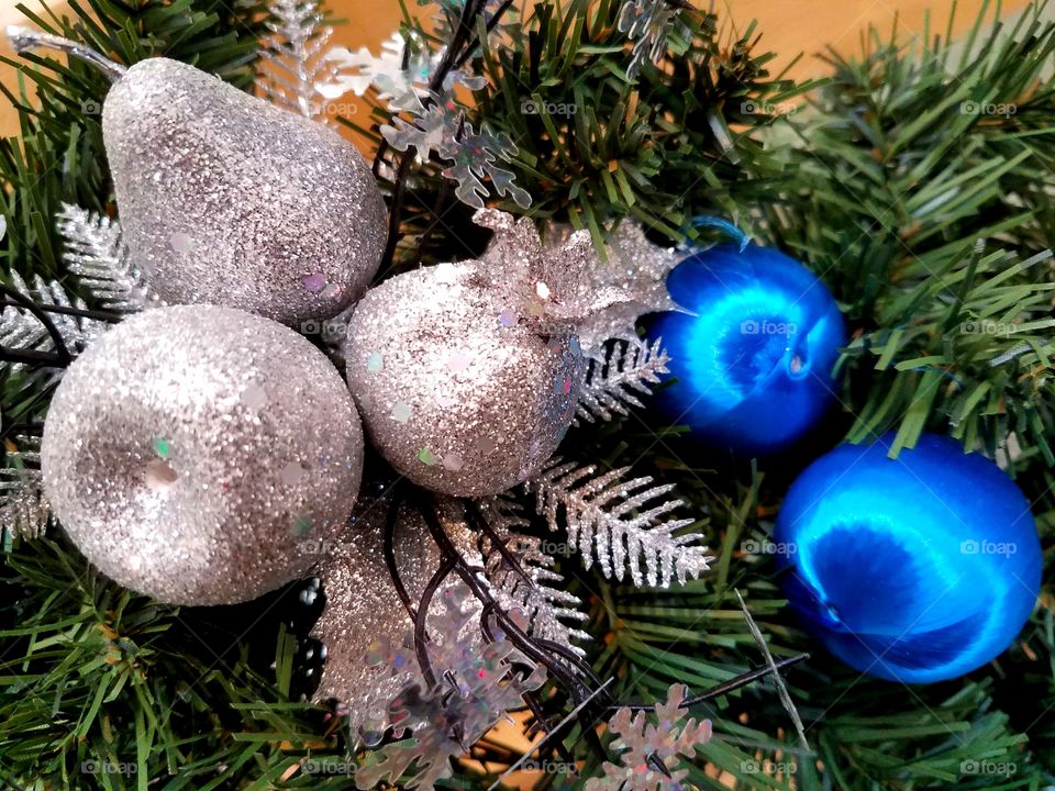 Blue and silver ornaments on a Christmas tree