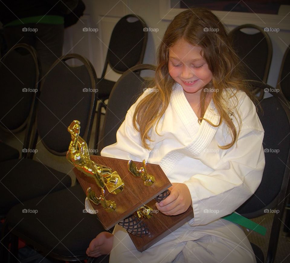 Girl looking at her award