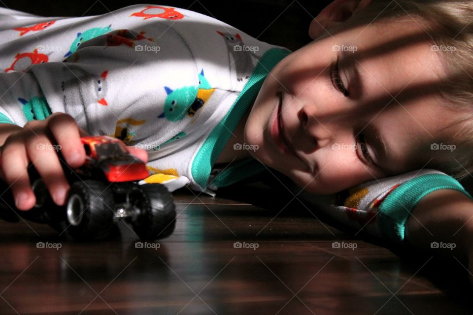 Little boy playing with car