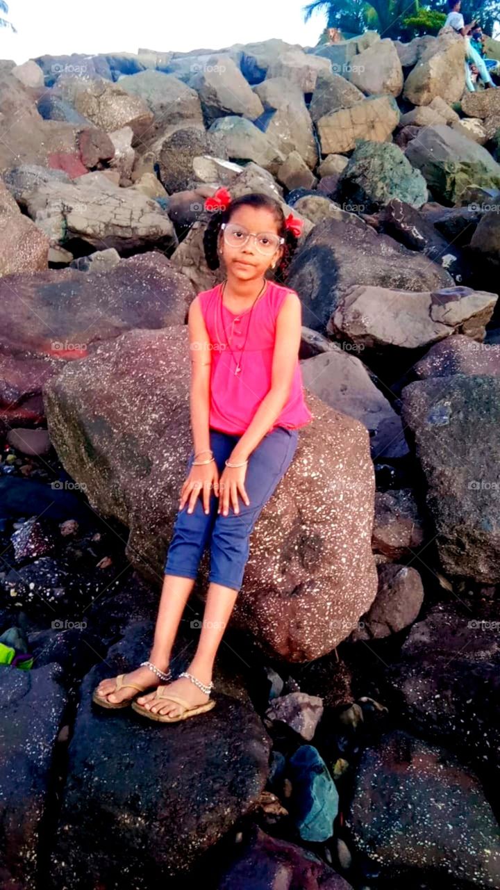 so cute little girl sitting on a big stone looks so pretty and so cute baby photo so pretty girl