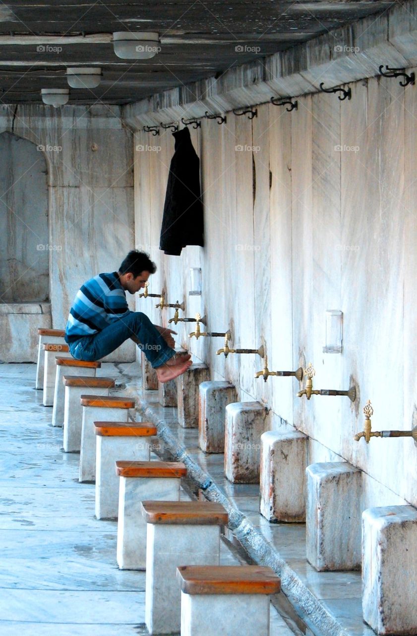 Washing feet at Blue Mosque. Man washes feet before entering the Blue Mosque in Istanbul, Turkey