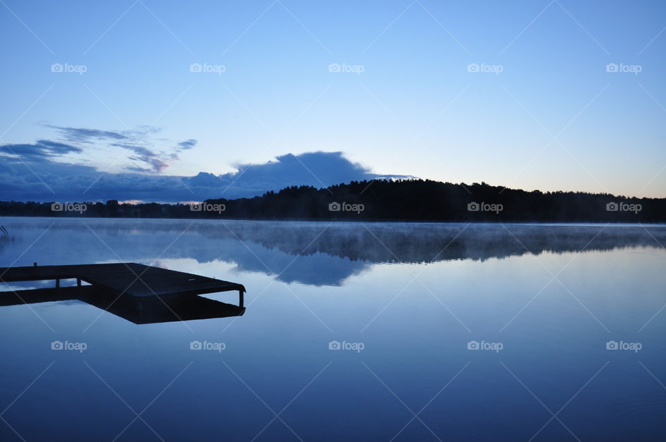 foggy morning at the lake in polish countryside