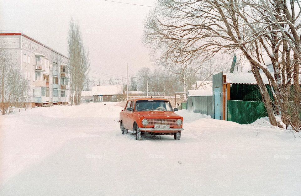Old cart in the middle of the yard in the winter 