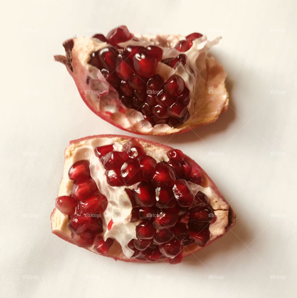 slice pomegranate seeds on white background 