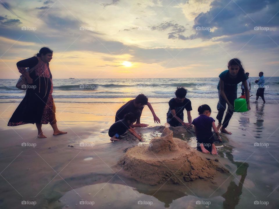 playing in the beach during sunset