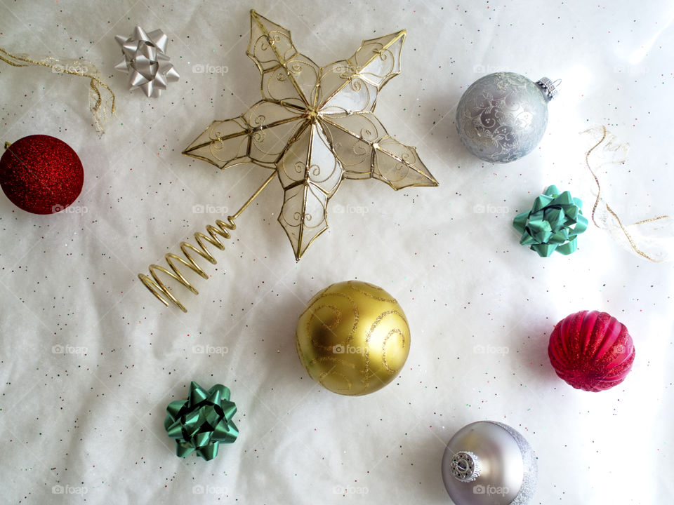 Christmas decorations on a white sparkly background.