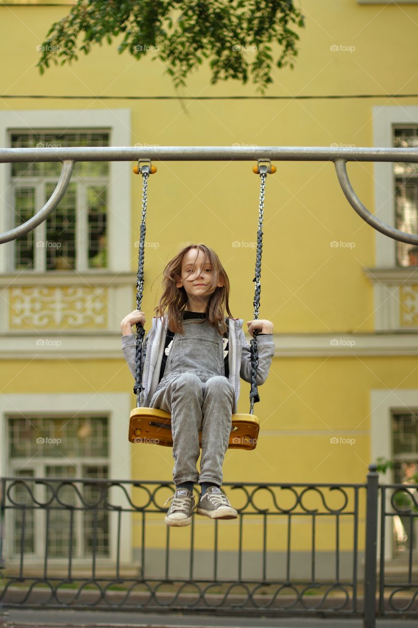 Girl swinging on a swing