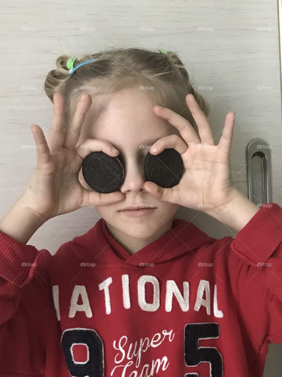 Girl with Oreos for glasses
