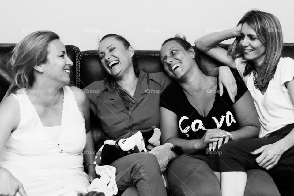 Four girl friends together after a couple of years  having a great time and laughing out loud 