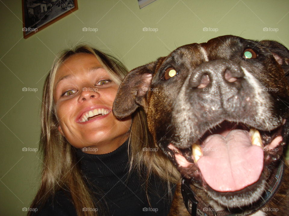 Young girl and a dog with mouth open looking at camera
