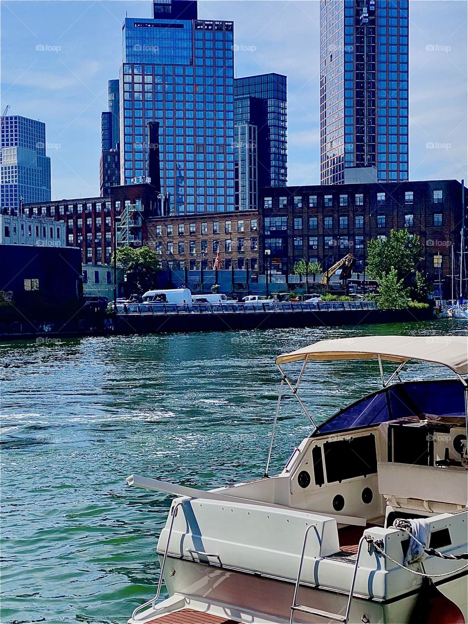 A certain unruliness that can still be seen in the water of the “East River” here at “Newtown Creek” by the “Pulaski Bridge” in LIC, Queens came about after a large commercial barge passed by here only minutes ago. 2023. Hypnotic Productions