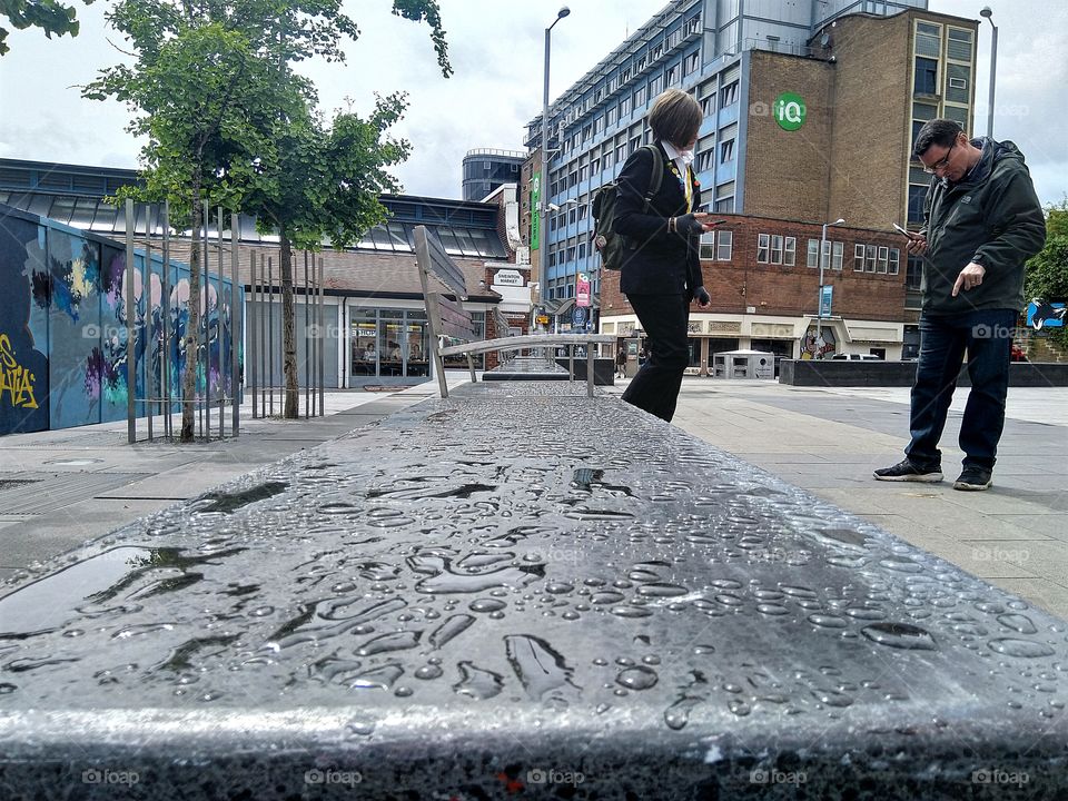 water droplets on a slab next to some chairs