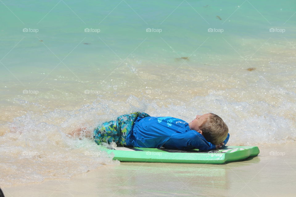 kid resting under surf table