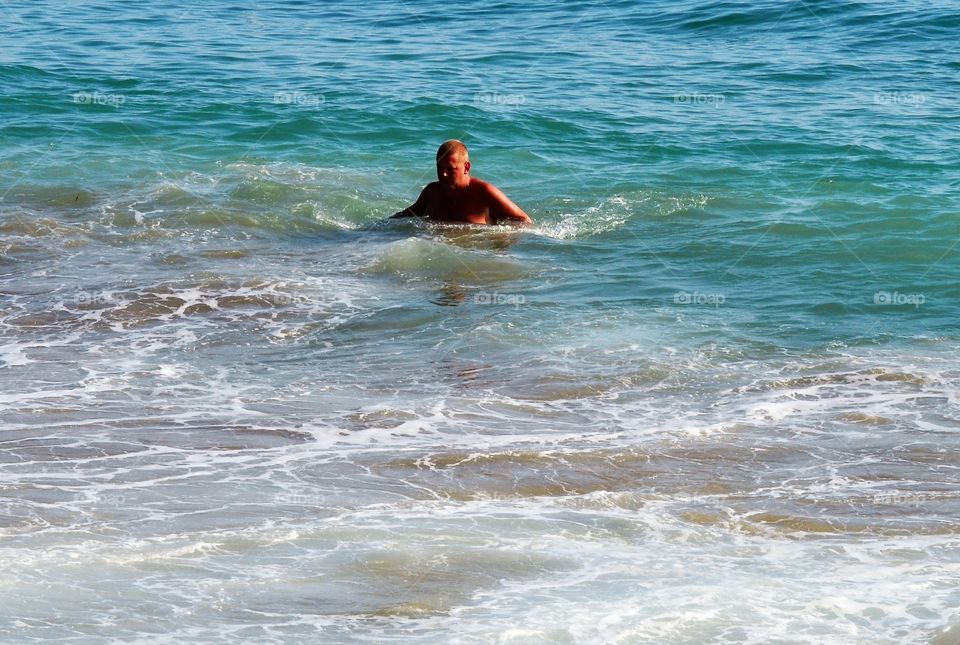 Senior man swimming in sea