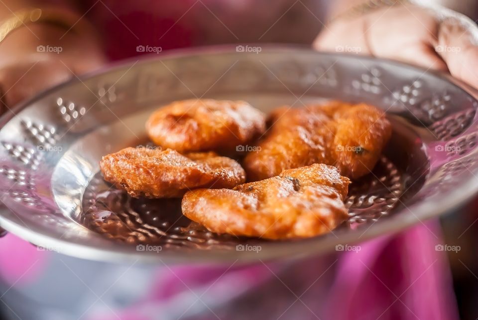 holding Indian food 