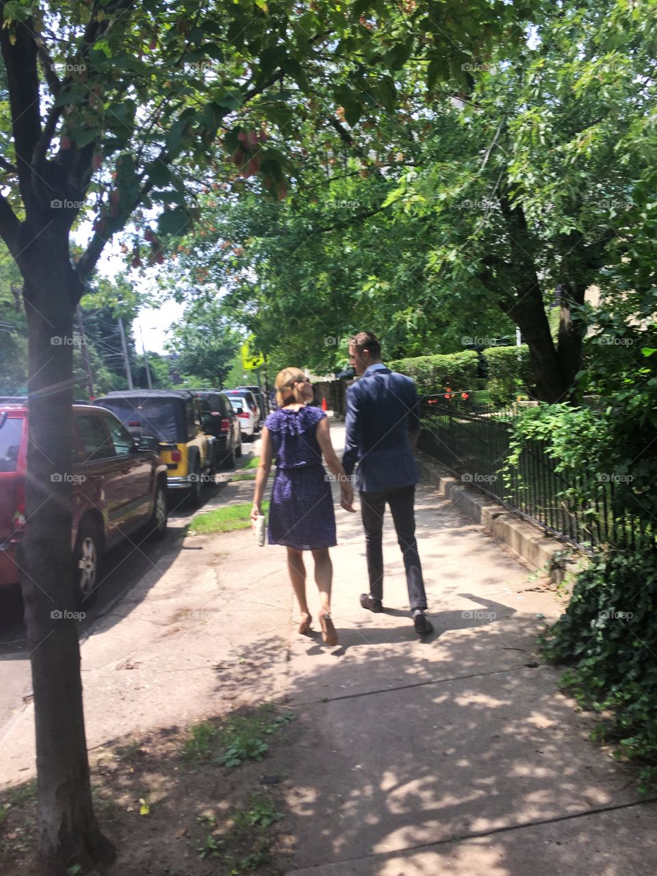 Walking. A couple walking on the sidewalk.