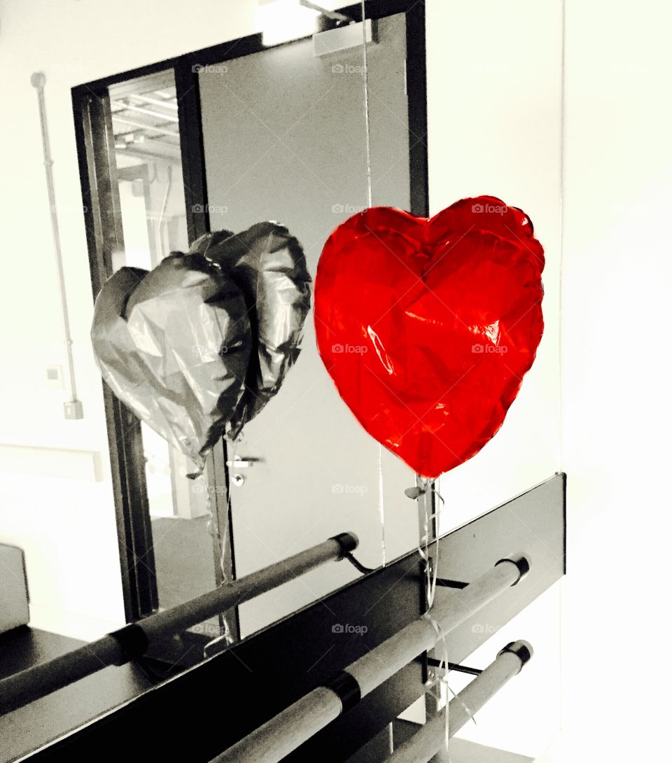 Heart shaped balloon . Reflection of a red heart shaped balloon.
